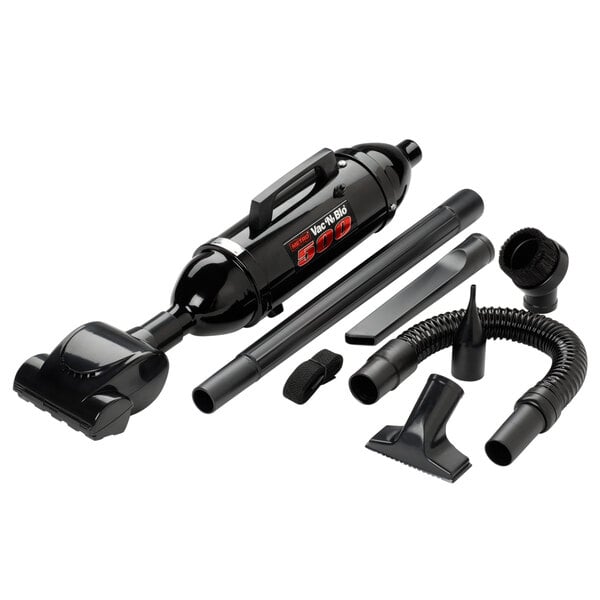 A black MetroVac VM12500T Vac N Blo 500 handheld canister vacuum with nozzles and various accessories.