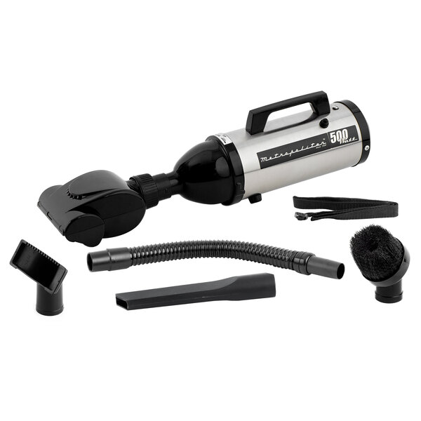 A MetroVac Evolution handheld canister vacuum with accessories including a hose and turbine brush.