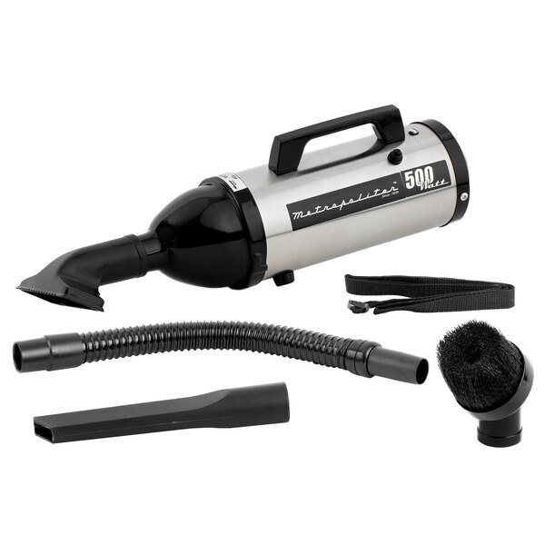 A MetroVac Metropolitan Evolution handheld canister vacuum with a tube and brush attachment.