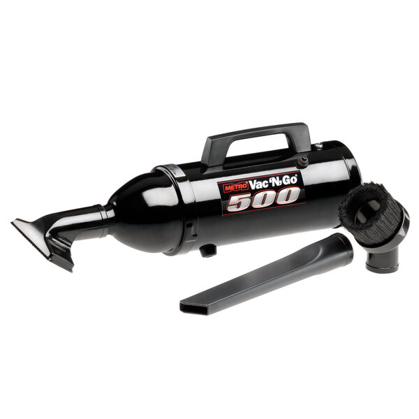 A black and silver MetroVac Vac N Go handheld canister vacuum cleaner with a hose.