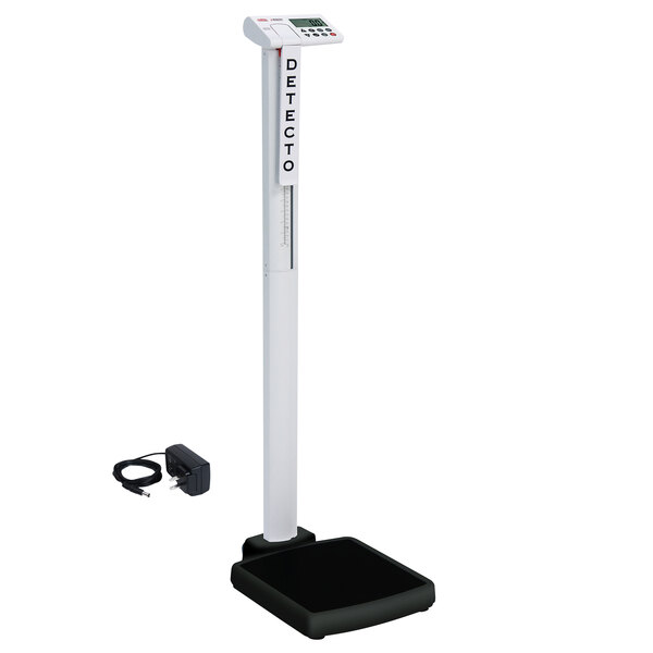 A white Cardinal Detecto digital scale with a black base and AC adapter.