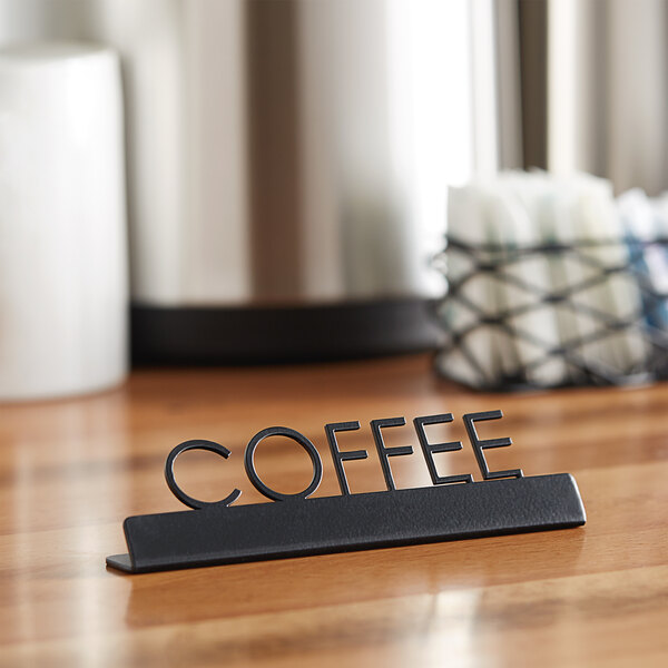An American Metalcraft black laser-cut table sign with "Coffee" on a table.