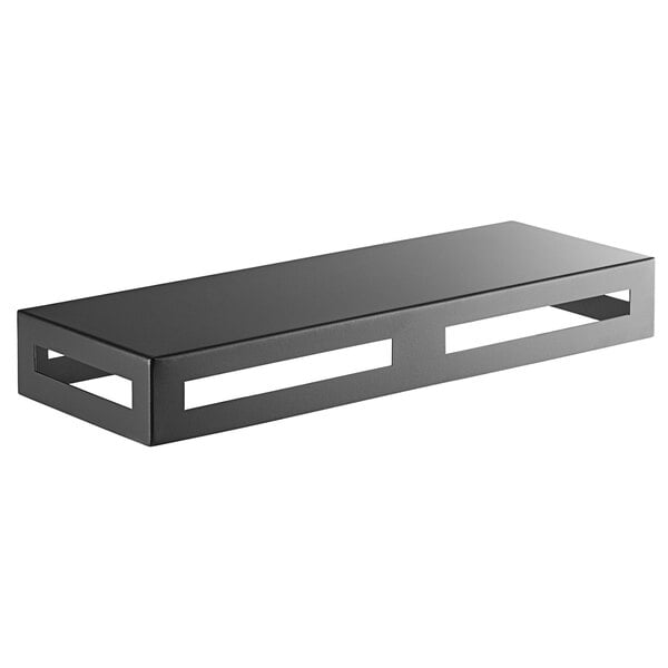 A black metal rectangular multifunctional riser with cut out holes on top.