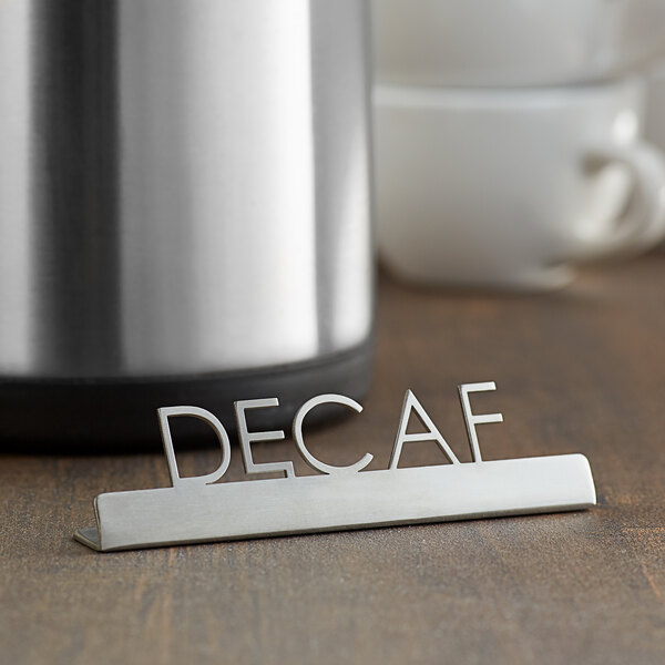 A stainless steel American Metalcraft tabletop sign with "Decaf" laser-cut in it.