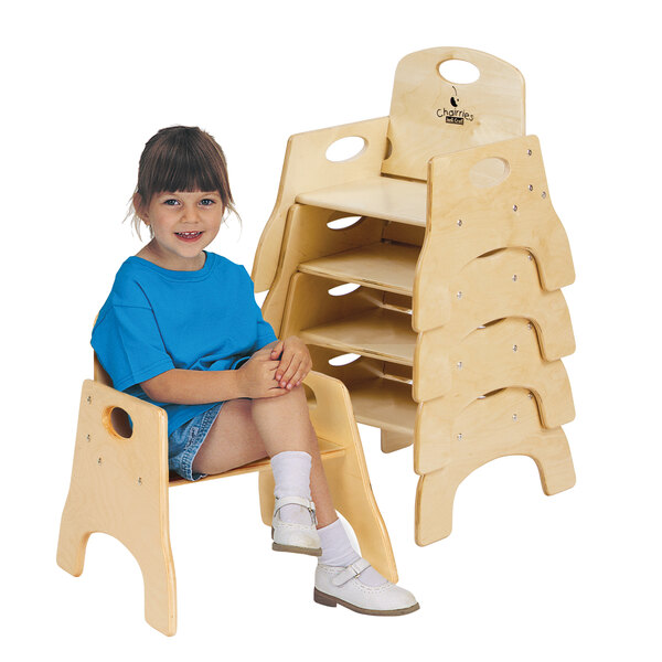 A young girl sitting on a Jonti-Craft wooden toddler chair.