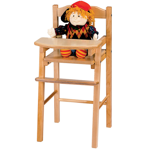 A doll sitting on a Jonti-Craft traditional wooden high chair.