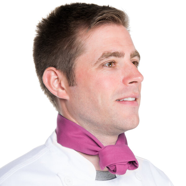 A man in a chef's uniform wearing a mauve Intedge chef neckerchief.
