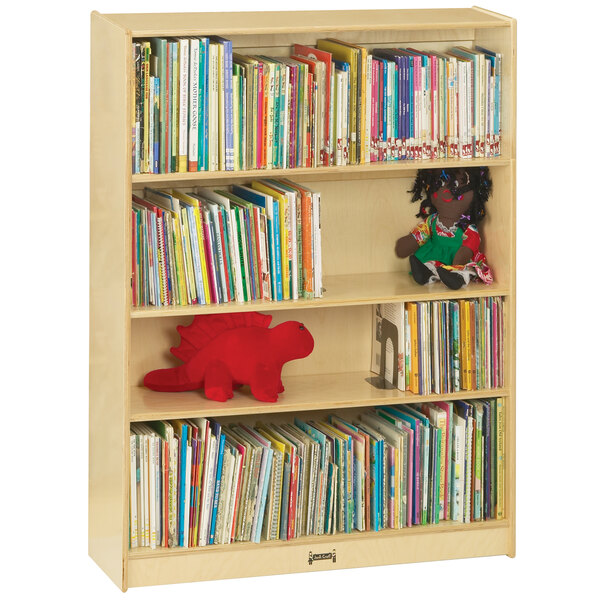 A Jonti-Craft natural wood bookcase full of books and toys.