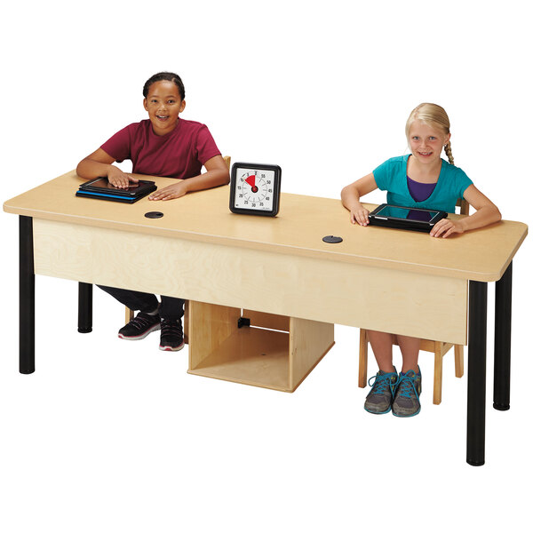 A group of children sitting at a Jonti-Craft dual children's wood computer lab table with tablets.
