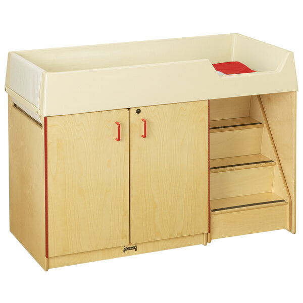 A Jonti-Craft wooden diaper changing cabinet with red and white accents.