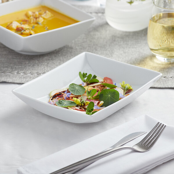 A Sant'Andrea Nexus bright white rectangular porcelain platter with food on it.