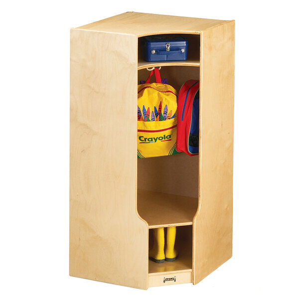 A Jonti-Craft wooden corner coat locker with a pair of shoes and a backpack.
