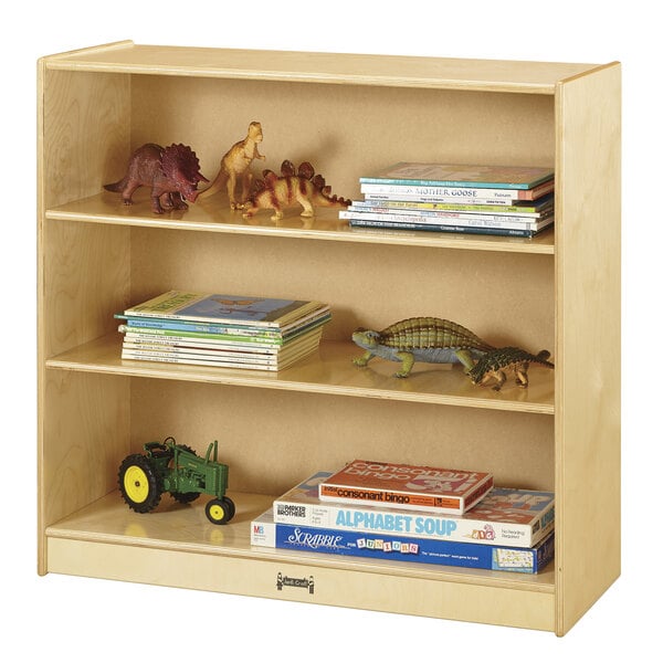 A Jonti-Craft natural wood bookcase with toys and toy dinosaurs on the shelves.