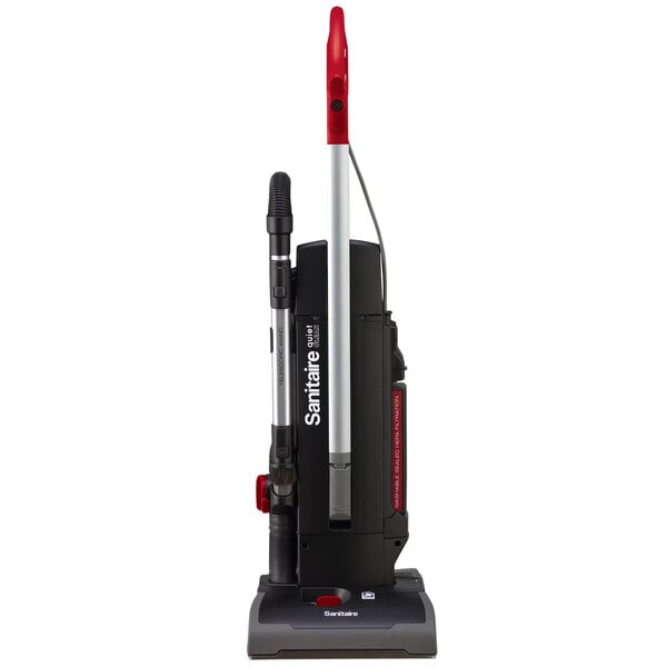 A Sanitaire bagged upright vacuum cleaner in black and red with a red handle.