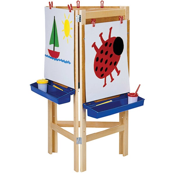 A Jonti-Craft wooden easel with a painting of a red ladybug on a white board.