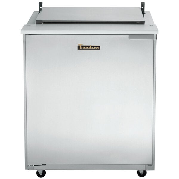 A stainless steel Traulsen sandwich prep table with a rectangular lid.