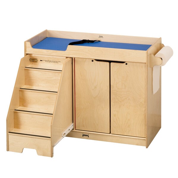 A Jonti-Craft wooden changing table with paper roll dispenser and safety strap.