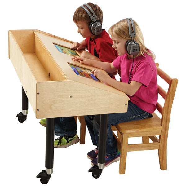 A boy and a girl use Jonti-Craft dual wood tablet table with headphones.