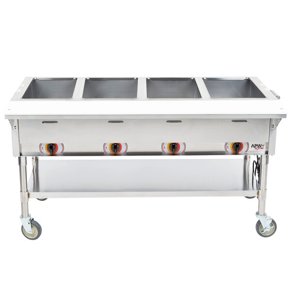 An APW Wyott stainless steel sealed well steam table with four pans on a counter.