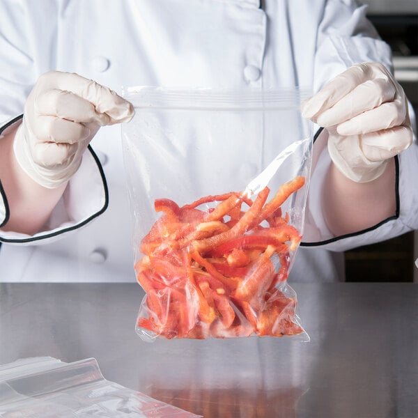 A chef holding a LK Packaging plastic food bag of red peppers.