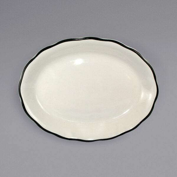 A white stoneware platter with a black rim.