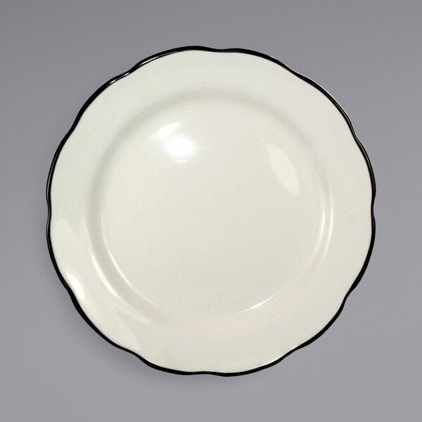An International Tableware Sydney scalloped stoneware plate with a black rim on a white background.