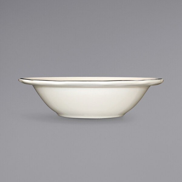An ivory stoneware bowl with a black rim.