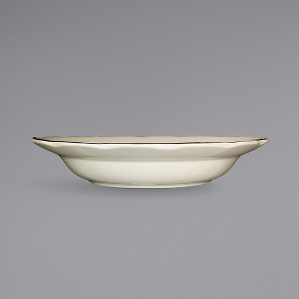 A close up of an International Tableware Sydney stoneware bowl with a black rim on a white background.