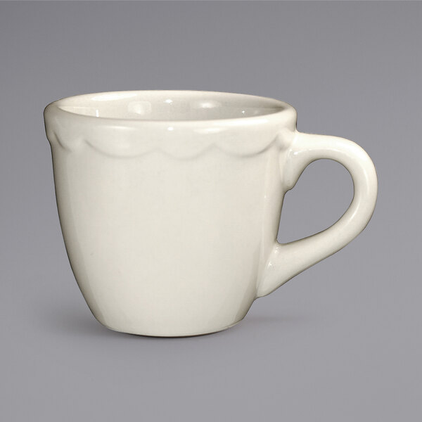 A white International Tableware Victoria stoneware espresso cup with a handle.