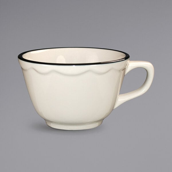 A white International Tableware stoneware cup with a black rim.