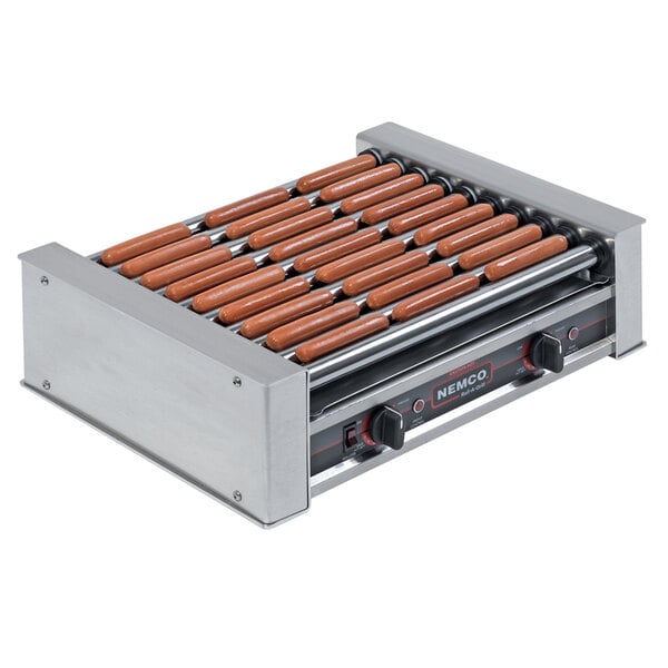 A Nemco slanted hot dog roller grill with hot dogs in a row.
