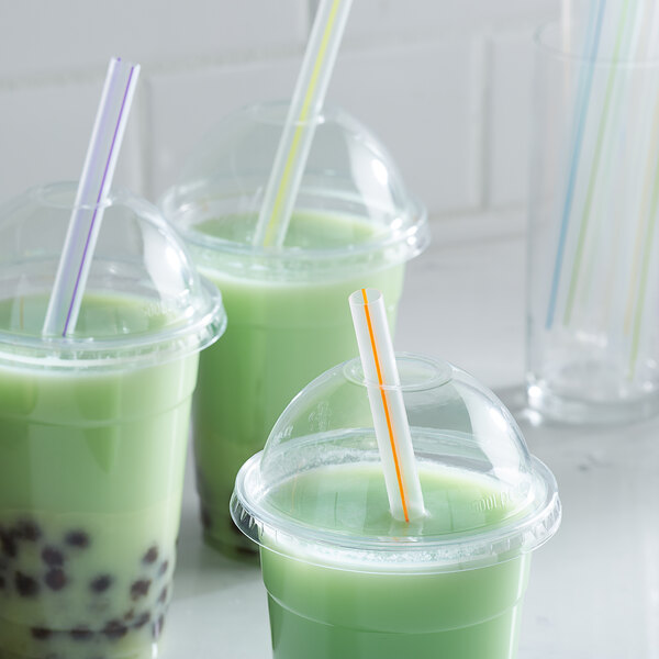 A group of green drinks with Choice multicolor striped straws.