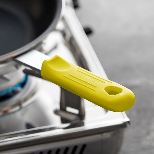 Yellow Choice silicone pan handle sleeve on a pan handle.