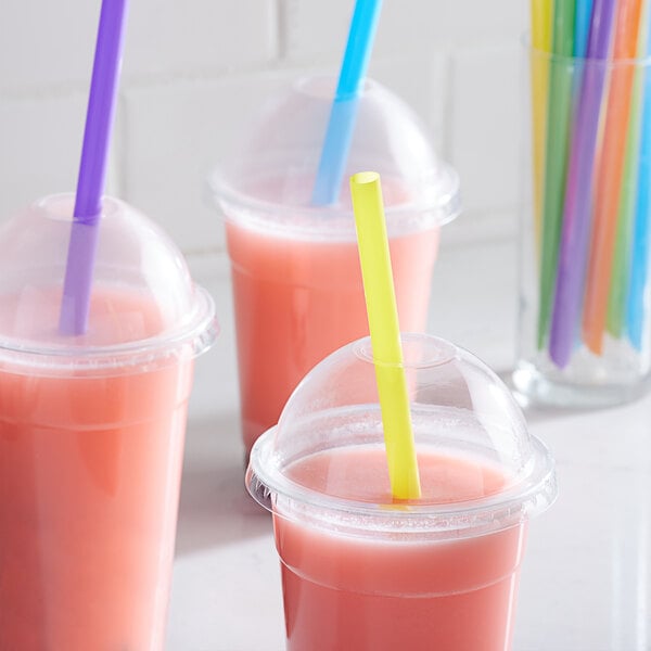 A purple, blue, and pink straw in cups.