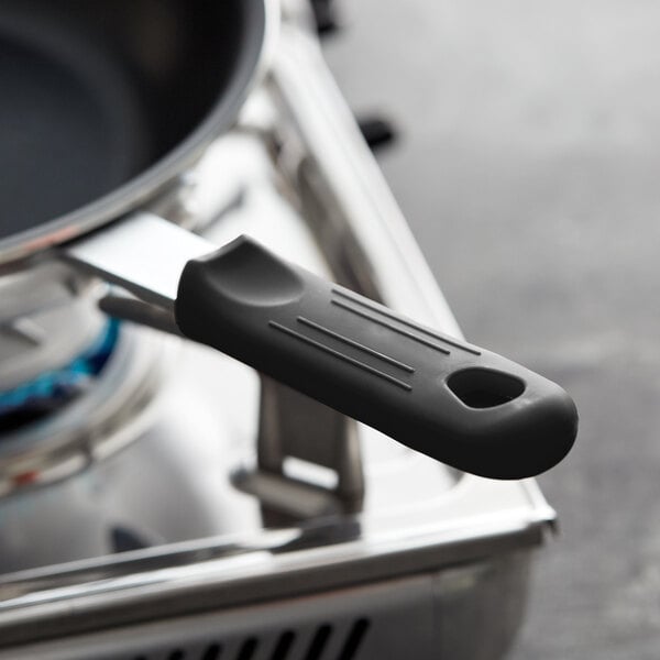 A black silicone pan handle sleeve on a pan.