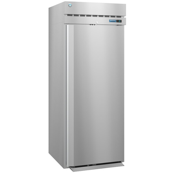 A stainless steel Hoshizaki roll-in refrigerator with a solid door open.