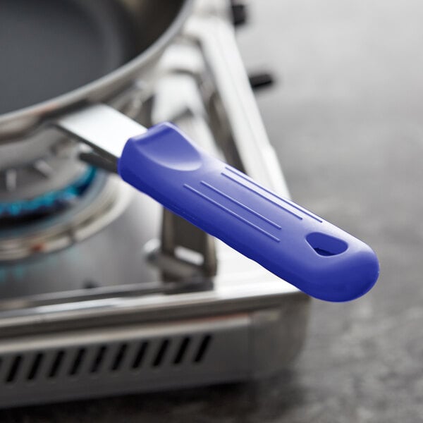 A blue Choice silicone pan handle sleeve on a pan.