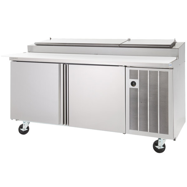 A large stainless steel Delfield refrigerator with a raised rail for pizza prep.