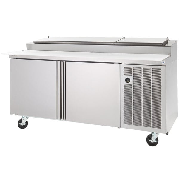 A large stainless steel Delfield pizza prep table with three doors.