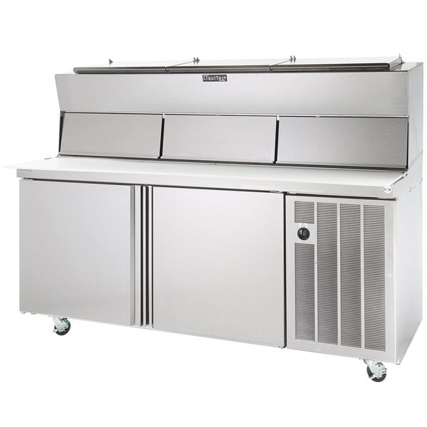 A Delfield stainless steel refrigerated pizza prep table with raised rails.