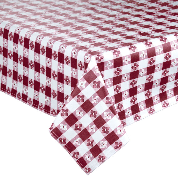 An Intedge burgundy gingham vinyl tablecloth with white checks on a table.