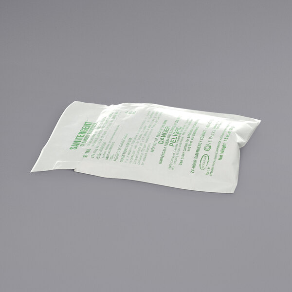 A white plastic bag with green text, containing a small bag of white Spaceman sanitizer cleaner.