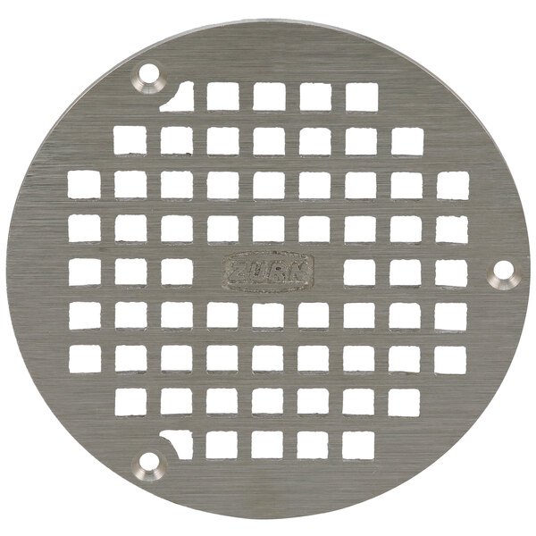 A Zurn polished nickel bronze circular metal grate with holes in it.