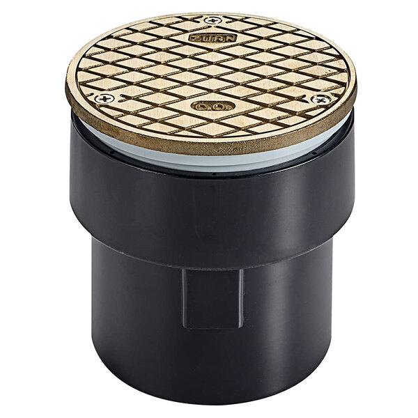 A black and gold circular metal drain cover with a diamond pattern and Zurn nickel bronze head.