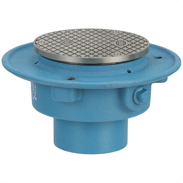 A Zurn round cast iron floor drain access with a blue and silver metal cover.
