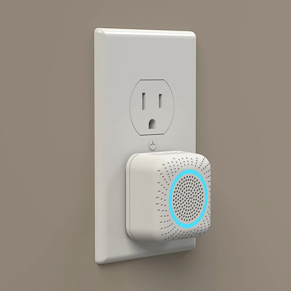 A white square Victor Pest Mini Pestchaser with a blue circle on it plugged into a white outlet.