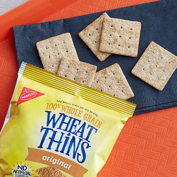 A bag of Nabisco Wheat Thins crackers on an orange tray.