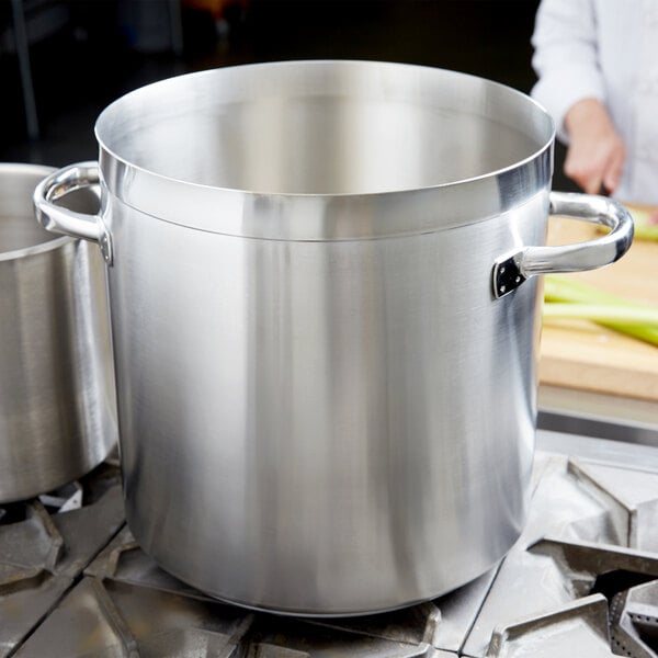 A large Vollrath stainless steel stock pot on a stove.