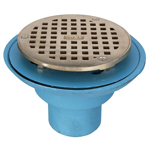 A blue Zurn cast iron shower drain with a silver metal round strainer cover.