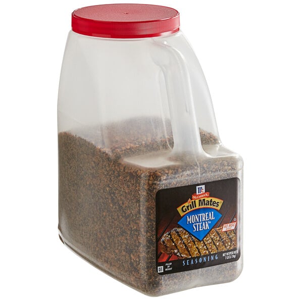 A plastic container of McCormick Grill Mates Montreal Steak Seasoning with a red lid.
